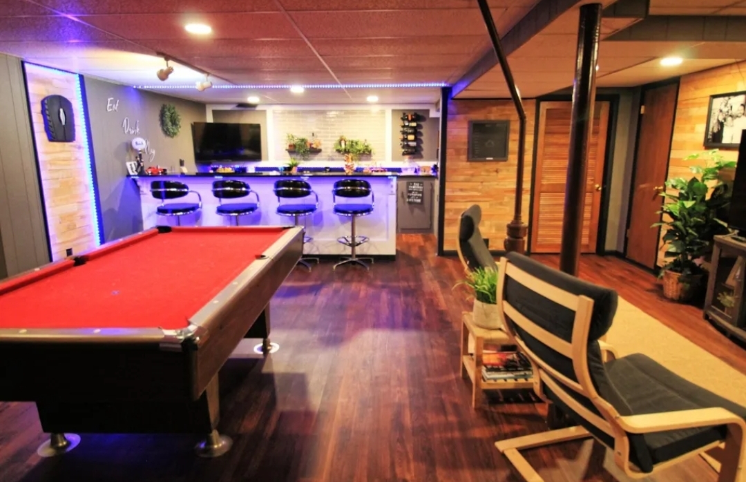 Basement after — modern bar with LED lighting, pool table, accent wall