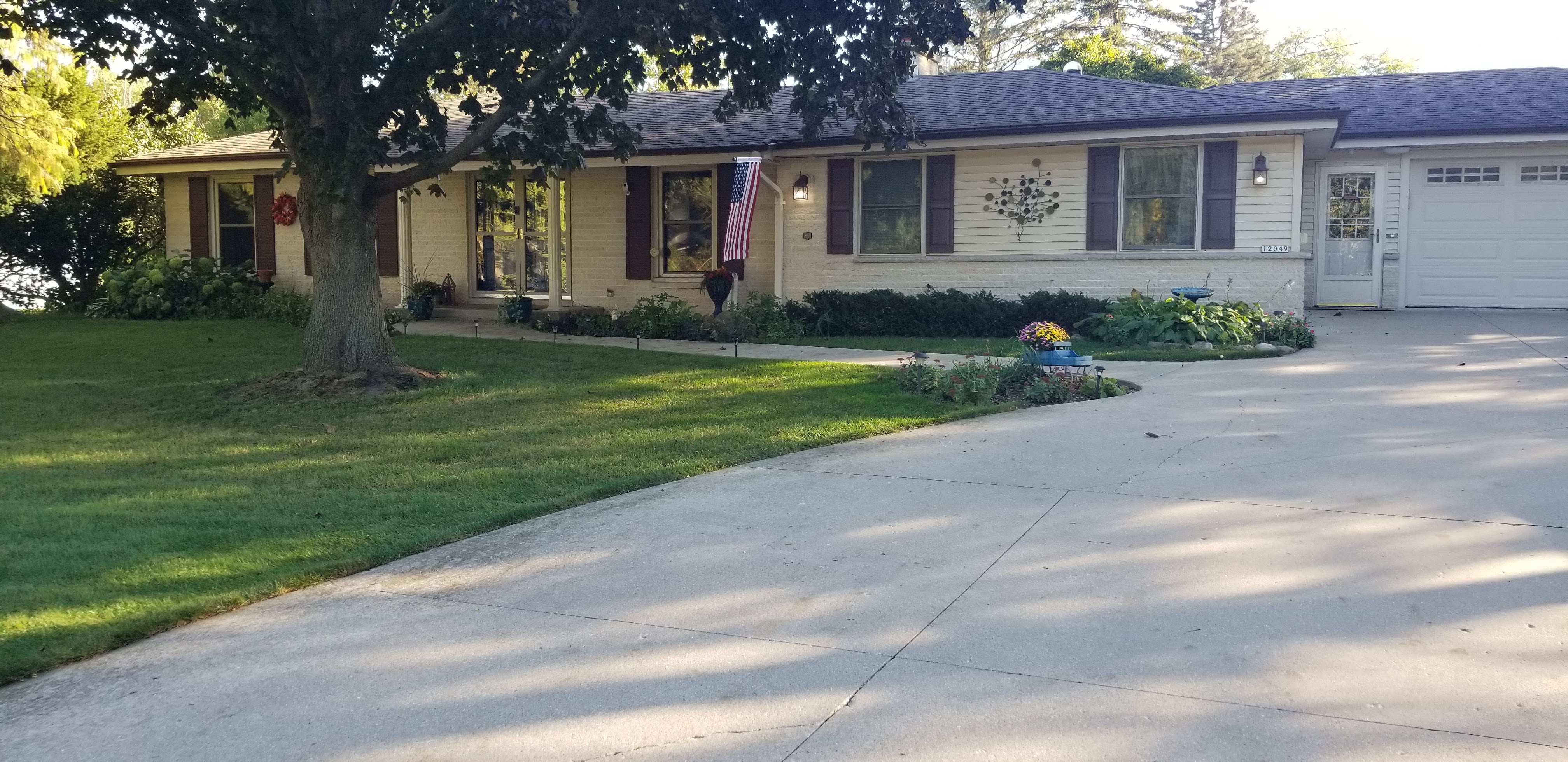 Exterior before — original painted shutters and entry