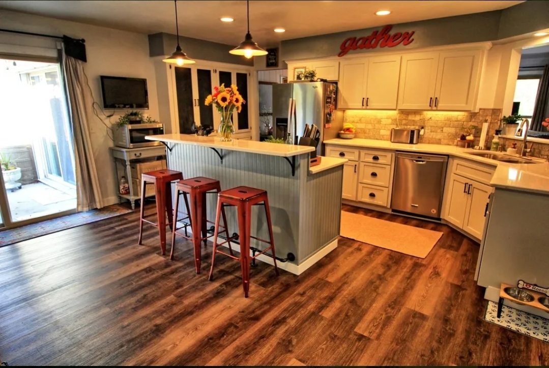 Kitchen after — painted white cabinets, new island, updated styling