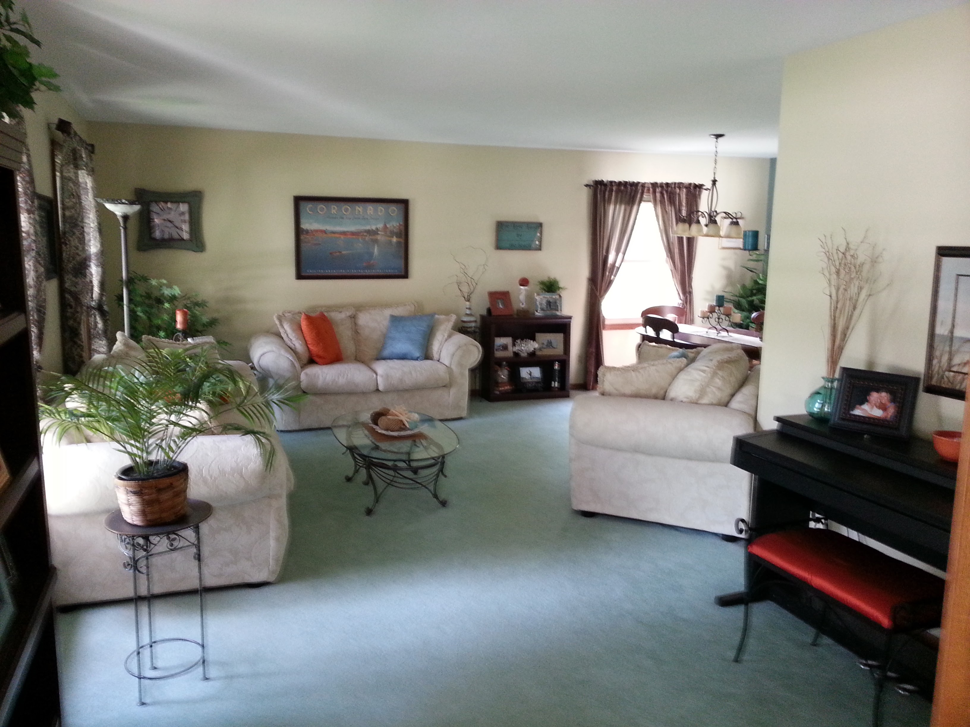 Living room before — dated furniture arrangement, beige walls